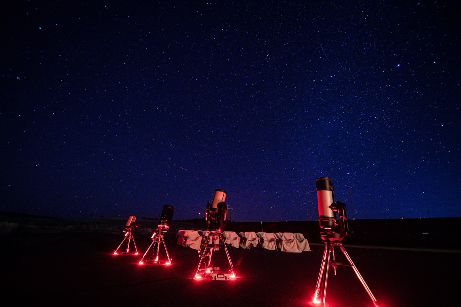 Telescopes set up at a Bryce Canyon Stargazing tour site under a starry night sky